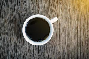 Top view of coffee on wooden background photo