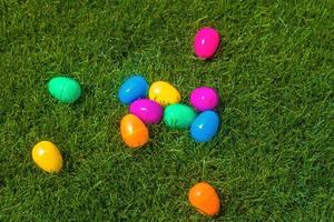 Plastic easter eggs on grass photo