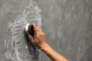 Hand scrubbing a wall photo