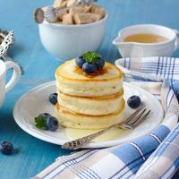 Stack of scotch pancakes with honey and blueberries photo