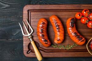 Grilled sausage with tomato and ketchup photo