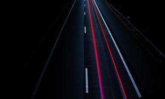 Long-exposure of brake lights on road photo