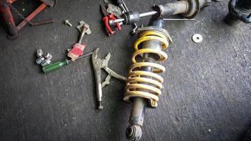 Shock absorber for a car on mechanic floor photo