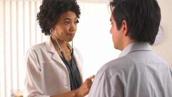 Female doctor using stethoscope with Hispanic patient video