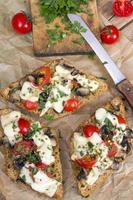 delicious bruschetta with tomatoes, cheese and mushrooms photo