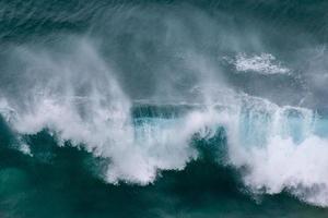 Dramatic ocean waves crashing near shore photo