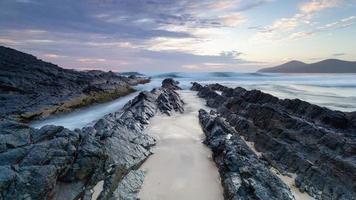 Rocky shore under a muted sunset photo