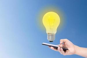 Smartphone and light bulb photo
