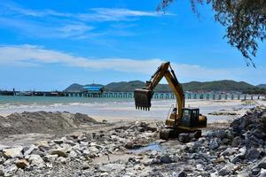 Crawler excavator moving rocks photo