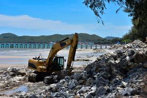 Crawler excavator moving rocks. photo