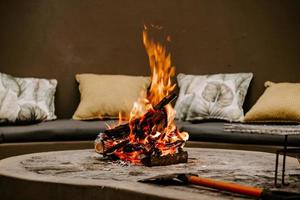 Fire burning in fire pit with an axe photo