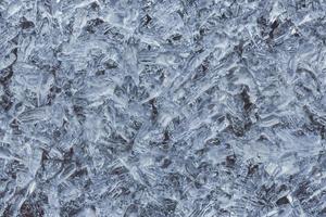 Close up shot of ice crystals on a metalic surface.