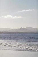 Ocean and mountains during the day photo