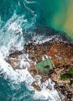 Aerial view of a rocky seashore during the day photo