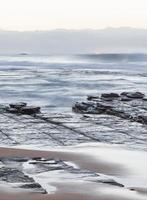 Long-exposure of waves on a beach photo