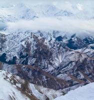 Bird's eye view of brown mountains covered in snow photo