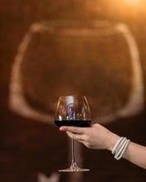 Woman holding wine glass photo