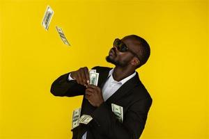 A cool black man throws up dollars
