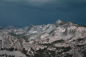 Mountain range under blue stormy sky during daytime photo