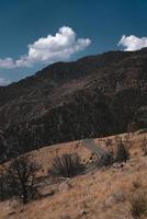 Gray asphalt road between mountains photo