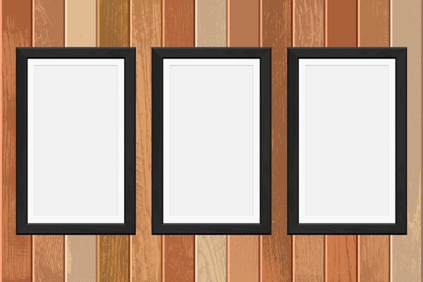 Wooden photo frames on a plank background