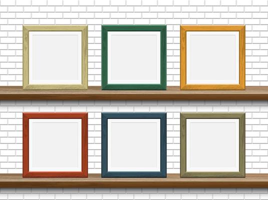 Wooden picture frames on shelves with white brick wall