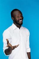 Attractive handsome African man smiles and gives his hand photo