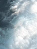 Aerial view of towers peaking from the clouds photo