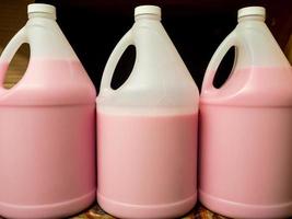 liquid hand soap pink plastic bottles janitorial sanitizer shelf handle photo