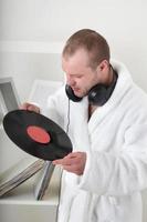 Young man with vinyl dick indoors photo