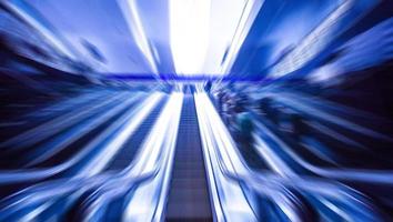 escalator on train station, view in blue tone.motion blur