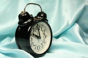 Alarm-clock on blue background photo