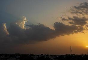 Sunset and clouds above a city photo