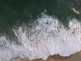 Sea waves crashing on seashore photo