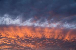 Streaks of golden sunlight across the clouds photo