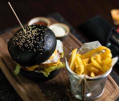 Black bread burger with French fried potatoes photo