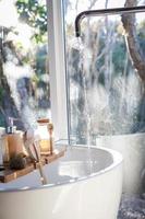 White ceramic sink near a window photo