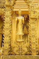 Statue on the golden temple of Wat Paknam Jolo photo