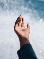 Hand in front of a wave photo