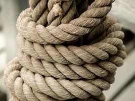 Worn rope tied in a knot photo