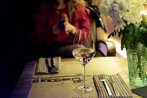 Glass of white wine on a restaurant table photo