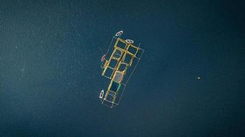 Aerial view of boats at a dock in the middle of the ocean photo