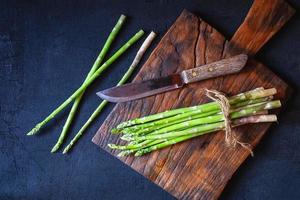 Asparagus on a wooden cutting board photo