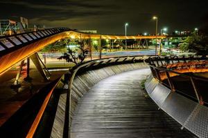 Wooden bridge with lights in a city at night photo