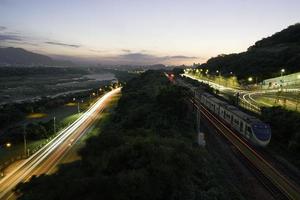 Time-lapse of vehicles and trains at night photo