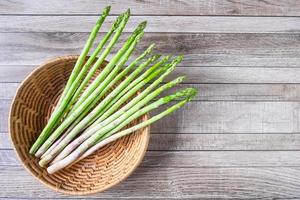 Asparagus in a basket on a table photo