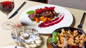 Cooked steak with lingonberry photo