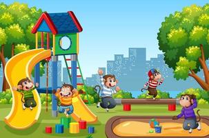 Five little monkeys jumping in the park playground scene vector