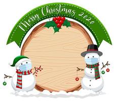 Blank wooden board with Merry Christmas 2020 font logo and snowman wearing mask vector