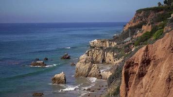 Waves of Malibu Beach Crash Against the Rocky Cliffs 4K video